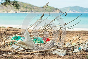 Spilled recycling garbage on beach of lazur sea. Used waste white foam and plastic bags. Environmental total pollution