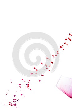 Spilled red wine drops forming a diagonal line on a white background