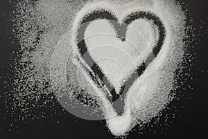 Spilled Sugar Heart Love Shape of Heart Black Background. unhealthy sugar. Love sugar Sweet.