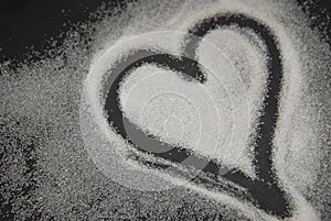 Spilled Sugar Heart Love Shape of Heart Black Background. unhealthy sugar. Love sugar Sweet.