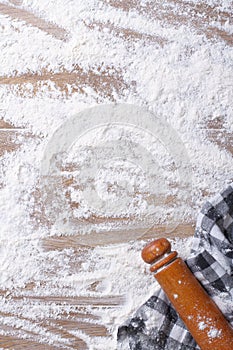 Spilling flour on the board, rolling pin and kitchen towel