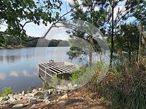 Spillway on Lake by Rocky Shore and Trees