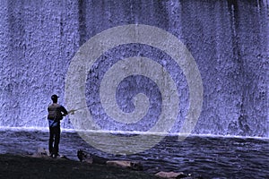 Trout fishing by a spillway