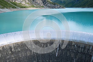 Spillway of Moiry Dam and turquoise water of Lac de Moiry, in Switzerland