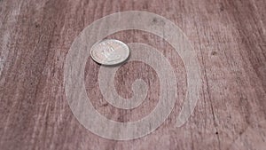 Spin of 2 Swiss Franc of Switzerland money on the wooden floor and stop in head side of a coin.