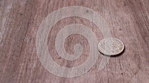 Spin of 2 Swiss Franc of Switzerland money on the wooden floor and stop in reverse of a coin with 1994.