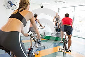 Spin class working out with motivational instructor