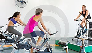 Spin class working out with motivational instructor