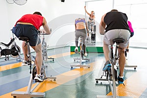 Spin class working out with motivational instructor