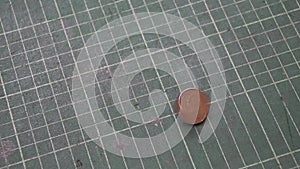 Spin of five baht of Thai money on the green cutting plate and stop in head side of a coin.