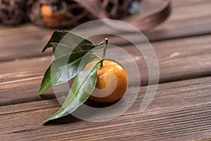 The spin of the tangerine close-up on brown wooden background. Ripe fruit