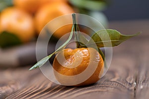 The spin of the tangerine close-up on brown wooden background. Ripe fruit