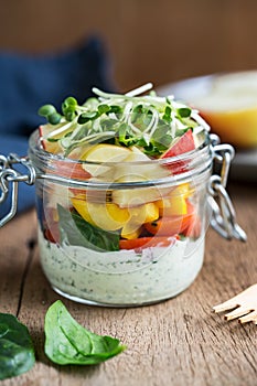 Spinach,apple and tomato salad in a jar