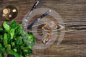 Spinach baby leaves on wooden background. Top view. Copy space