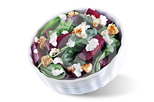 Spinach beet goat cheese walnuts salad on a white isolated background