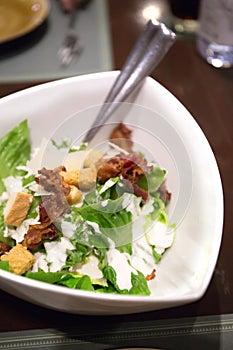 Spinach and bread salad on white plate