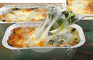 spinach with cheese in aluminium foil tray photo