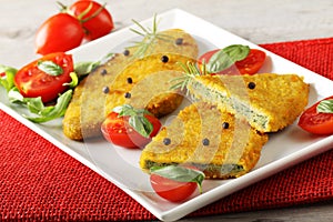 Spinach cutlets with tomato salad