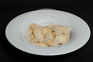 Spinach Dumplings in a white plate on a black background