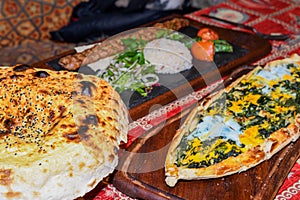 Spinach and egg pide, pita flat bread and puff hot lavash or lavas homebaked specialty
