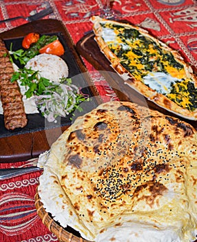 Spinach and egg pide, pita flat bread and puff hot lavash or lavas homebaked specialty