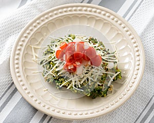 Spinach fritter topped with tomatoes and cheese