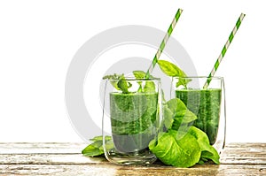 Spinach leaves smoothie in transparent glass. Healthy green drink