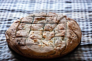 Spinach pie greek spanakopita round shape on kitchen table background