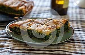 Spinach pie or greek spanakopita serving on kitchen table