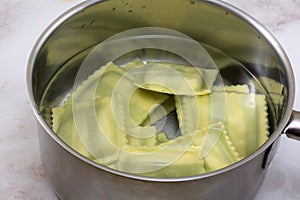 Spinach ravioli in stainless steel pan