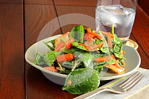 Spinach salad served with yogurt dressing