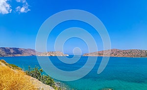 Spinalonga island with blue sky and transparent sea. Elounda, Spinalonga, Crete, Greece. Traveling at Crete, summer vacations and