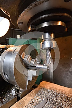 Spindle chuck and installed metal part in pocessing on high precision Cnc industrial lathe turning machine. CNC machine cuts off