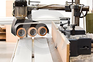 A Spindle moulder machine with power feed in a modern carpentry work shop used for cutting and shaping wood