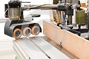 A Spindle moulder machine with power feed in a modern carpentry work shop used for cutting and shaping wood