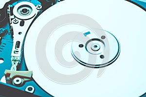 Spindle and plate opened hard disk drive HDD. Macro shot. Computer storage