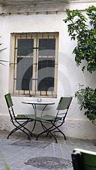 Spindly chairs in shady secluded courtyard