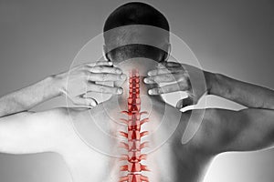 Spine pain, man with backache and ache in the neck, black and white photo with red backbone