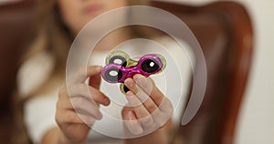 Spinner concept. little girl playing with spinners to camera.