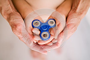 Spinner in the hands of mother and child.