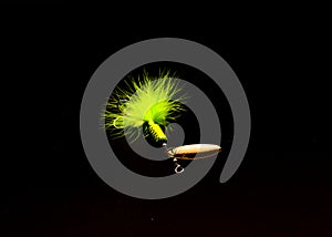 Spinner Lure with three hooks spinnerbaits pulsating hackle tail isolated on black