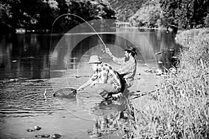 Spinnerbait. fly fish hobby of men in checkered shirt. retirement fishery. happy fishermen friendship. Two male friends photo