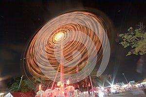 Spinning of amusement park rides in the theme park in Bangkok, Thailand
