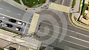 Spinning around road junction with cars, aerial footage of road cross in town