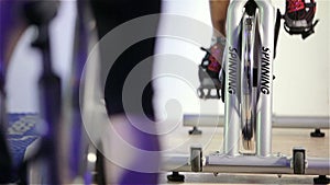 Spinning class: feet pedalling on exercise bikes