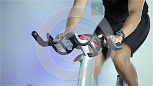 Spinning class: sprint cycling on exercise bike