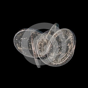 Spinning coin in stroboscopic light on dark background. One dollar coin with Abraham Lincoln. Stroboscopic effect