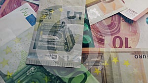 Spinning Euro banknotes and medicines. COVID-19 pandemia, economic crisis