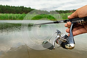Spinning fishing is an exciting activity. Sport fishing. Copy space.