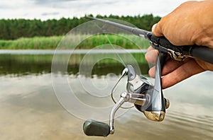 Spinning in the male hand, the river, sport fishing predatory fish.